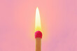 Pink match with flame on pink background - Concept of women and creative thinking