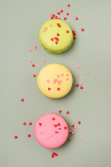 Wall Mural - French Macaroon or Macaroons on Green Background Tasty Modern French Dessert Vertical