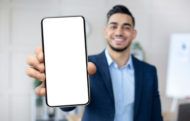 Poster - Handsome Arab Businessman Showing Smartphone With Blank White Screen At Camera