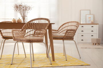 Wall Mural - Dining room interior with wooden table and wicker chairs