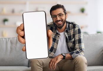 Poster - Cheerful Indian Guy Showing Smartphone With Big Blank White Screen At Camera