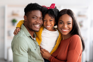 Wall Mural - Happy Family. Portrait Of Smiling Black Parents And Their Cute Little Daughter