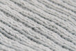 © Anna - Close-up of hand-knitted garment (2x2 rib stitch) in pale blue. Diagonal view.