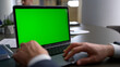 © stockbusters - Business man using touchpad laptop green screen on corporate team conference.