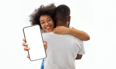 Poster - Pretty black lady hugging her boyfriend and showing smartphone, mockup