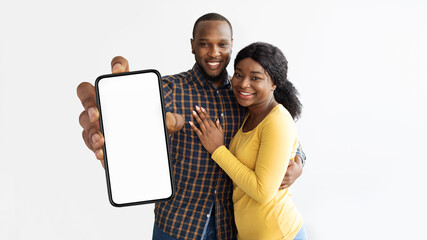 Poster - Beautiful african american lovers showing cellphone with empty screen