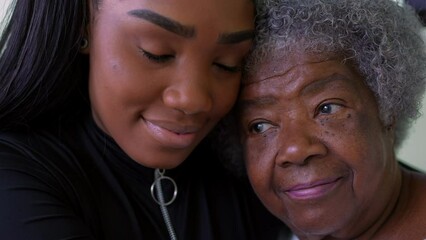 Wall Mural - A teen granddaughter embracing senioro grandmother showing love kissing grandparent on forehead