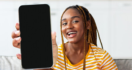 Poster - Mobile Offer. Cheerful Black Woman Demonstrating Smartphone With Big Blank Screen