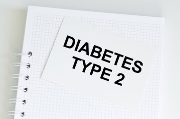 Wall Mural - text diabetes TYPE 2 on a card with a white notepad on the table, medical concept