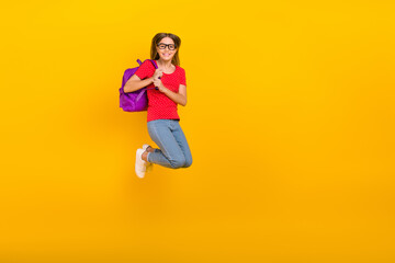 Wall Mural - Full body photo of young girl jump energetic hold bag courses academic isolated over yellow color background