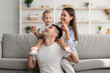 © Prostock-studio - Family Relations. Happy Mom And Dad Playing With Infant Child At Home