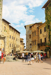 Tourists exploring the town square and restaurants of San Gimignano, outside Florence, Italy.