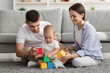 © Prostock-studio - Happy Young Caucasian Family Playing Together With Little Baby Son At Home