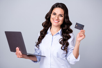 Canvas Print - Photo of confident banker lady hold netbook debit card wear glasses blue shirt isolated grey color background