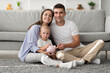 © Prostock-studio - Family Economy. Happy Mother, Father And Toddler Child Holding Piggy Bank