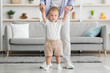 © Prostock-studio - Portrait Of Adorable Toddler Boy Walking With Mother's Help At Home