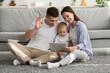 © Prostock-studio - Online Communication. Family With Little Baby Making Video Call On Digital Tablet