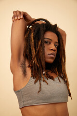 Studio shot of woman sitting on chair and talking on smart phone