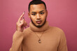© Cultura Creative - Studio portrait of queer man against purple background