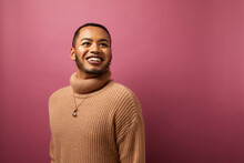Studio Portrait Of Queer Man Against Purple Background