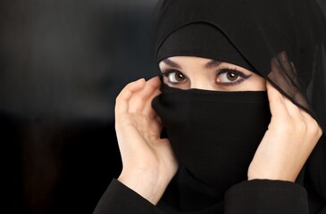 Sticker - Portrait of young woman in black burqa with hidden face,