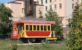 Fototapeta Londyn - Kazan street in summer, Tatarstan, Russia - July 18 2021v- Retro tram. Place is tourist attraction of Kazan. Girl having fun with old vintage tramway. Transport, people travel and sightseeing concept.