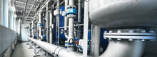 Large Industrial Water Treatment And Boiler Room. Shiny Steel Metal Pipes And Blue Pumps And Valves.
