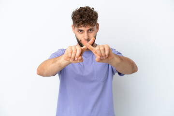 Young handsome caucasian man isolated on white background making stop gesture with her hand to stop an act