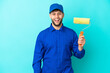 © luismolinero - Painter caucasian man isolated on blue background with surprise facial expression