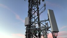 Cell Tower With Multiple 5G, 4G & LTE Antennas And Radio Dishes. Close-up Video From Drone With Tower Against Evening Sky.