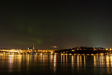 Northern Lights, Or Aurora Borealis, Over Stockholm City Skyline On A Cold Winter Night With Frozen Water. Night View Of Södermalm In Stockholm, Sweden. Photo Taken February 10, 2022.