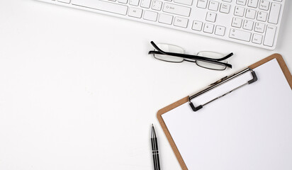 Poster - Directly above view of table, pen, papers and computer keyboard on the white background