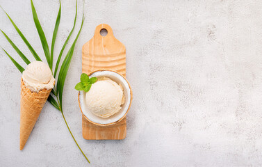 Fototapete - Coconut ice cream flavours in half of coconut setup on white stone background. Summer and Sweet menu concept.