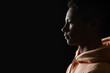 © Pixel-Shot - Silhouette of African-American teenage boy in hoodie on black background