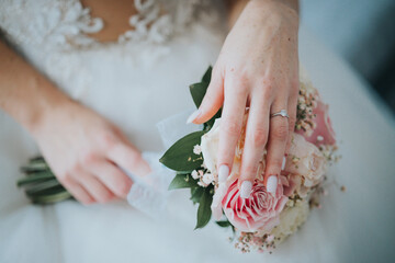 Poster - A Closeup of a bride holding a wedding bouquet