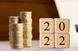 © BillionPhotos.com - 2022 NEW YEAR Business and saving money concept. Coins stack and blocks number 2022 on background.
