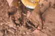Children playing and muddy hands