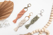 cotton macrame keychains are being displayed on a white background.