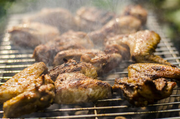 Wall Mural - A closeup shot of chicken on a barbeque net