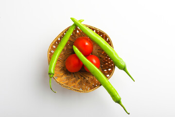 Wall Mural - Fresh Green chilli and tomatos on white background.