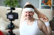 © H_Ko - Smiling man doing sports exercises at camera