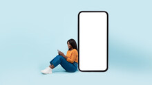 Black Lady Leaning On White Empty Smartphone Screen, Using Phone