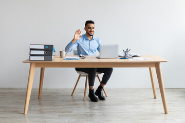 Aufkleber - Arab man using laptop waving hand making video call