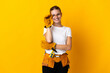 © luismolinero - Young electrician woman isolated on yellow background with glasses and happy