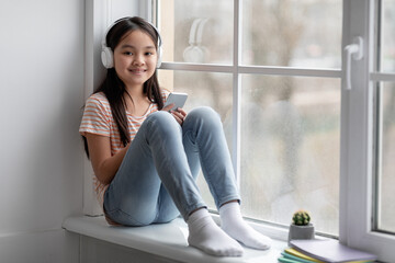 Pretty korean girl schooler spending time alone at home