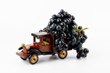Grapes In Toy Wooden Truck On White Background.