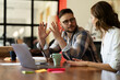 © JustLife - Colleagues in office. Businesswoman and businessman discussing work in office.