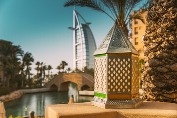 Traditional colorful handmade oriental lamp and lantern. View of Hotel Burj Al Arab, Tower of the Arabs is luxury hotel located in city of Dubai, Madinat Jumeirah is shopping, hotel and business