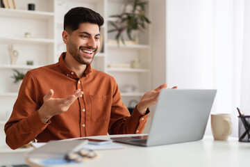 Poster - Arab man having video call using laptop and talking