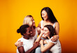 © iordani - diverse multi nation girls group, teenage friends company cheerful having fun, happy smiling, cute posing on yellow background, lifestyle people concept, african-american, asian and caucasian